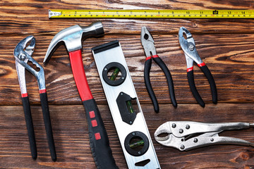 Close up tools on a wooden background.