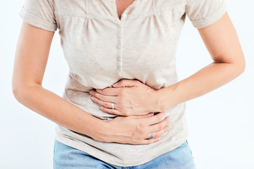 Woman with stomach/ hip issues / problems on the white background.