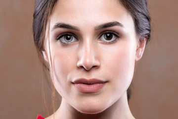 A close up face portrait of a beautiful young woman suffering from complete heterochromia iridis,...