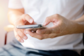 Close up of a man using mobile smart phone.