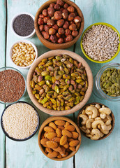 nuts, seeds and dried fruis on wooden surface