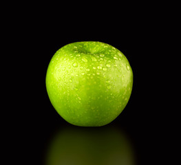 Green fresh Apple with leaf on black background