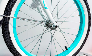 Bicycle wheel with metal spokes and turquoise rim