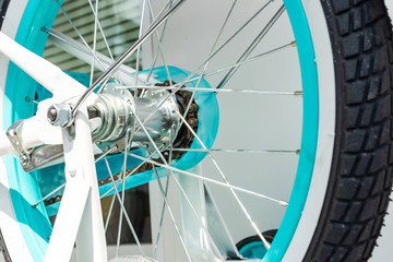 Rear wheel from bicycle with turquoise rim
