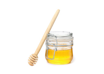 Dipper and glass jar with honey isolated on white background