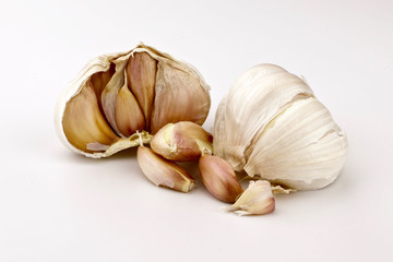 A bulb of garlic split open to expose the cloves
