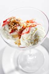 Two Ice Cream Balls or Iced Cream with Strawberry Sauce and Nuts
