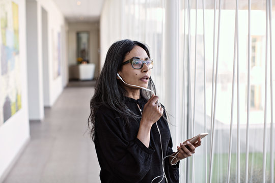 Businesswoman talking on smartphone in office