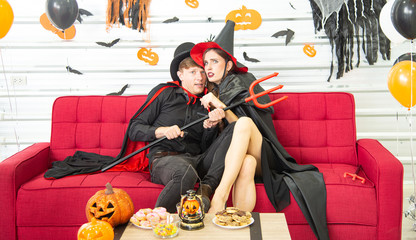 Obraz na płótnie Canvas Happy Halloween party concept. Young man and woman wearing as vampires, witch or ghost celebrate the halloween festival