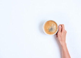 girl's hand holding coffee cup on white background, flat lay, top view
