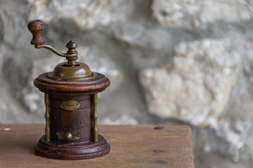 Old wooden grinder for pepper on wooden table in horizontal