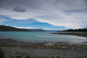 Lake Tekapo in Canterbury, New Zealand looking towards the mountains of Mt Cook/Aoraki National Park on a summer day