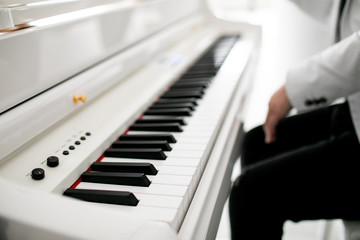 Close up of man hands piano playing. Male pianist hands on grand piano keyboard