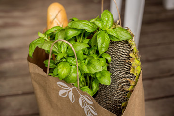 Various healthy food in paper bag on wooden background. Healthy food from the store
