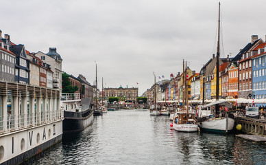 The boats and ships in the calm hurbour of Nyhavn, Copenhagen, Denmark.