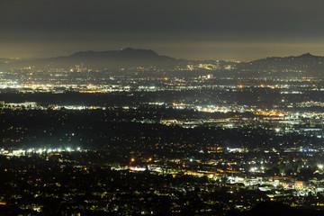 Fototapeta premium Night view across the San Fernando Valley towards Griffith Park and Studio City in Los Angeles, California.