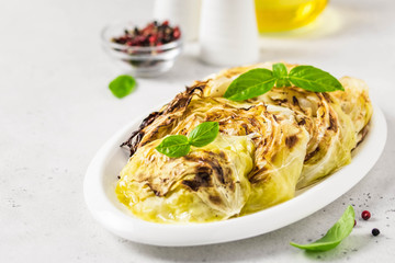 Spicy roasted cabbage steaks. Selective focus, copy space.