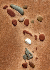 Fototapeta na wymiar Red sand beach on Prince Edward Island with stones and shells.
