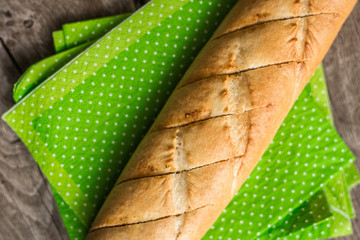 Sliced long french bread over wooden table. Baguette. Restaurant