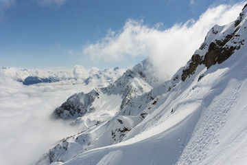 Winter mountain landscape and cloudy blue sky, Caucasus mountains.