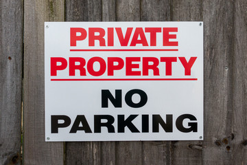 Private Property No Parking Sign on a wooden fence