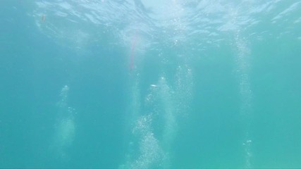 Bubbles rising from below underwater
