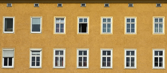 Panorama view of lots of windows on a yellow building