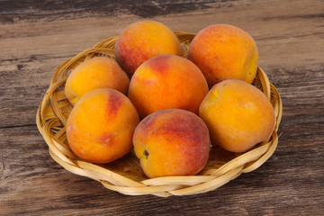 Peach heap in the wooden basket