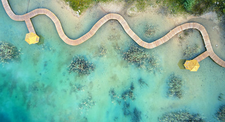 Aerial landscape from the drone - blue water and wooden bridge