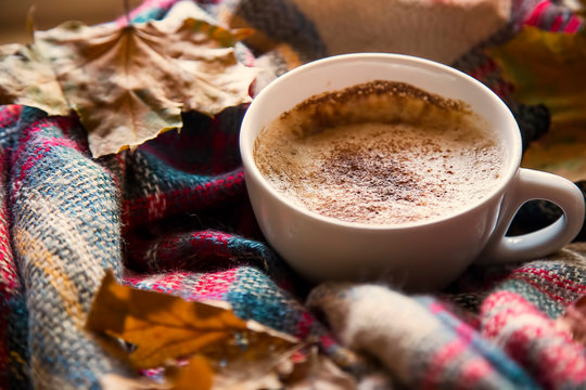 Autumn coffee cup with cozy blanket and dried leaves, fall deco warm home weekend with coffee cup, autumn concept, cozy lifestyle rustic view - Powered by Adobe