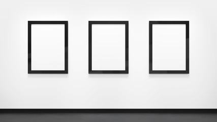 Three blank posters with black frames on the white wall. Picture gallery mockup.