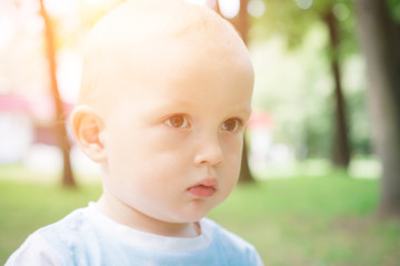 Portrait of young boy in nature, park or outdoors