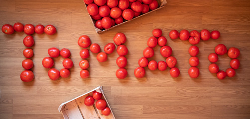 Word TOMATO made of raw fresh organic tomatoes