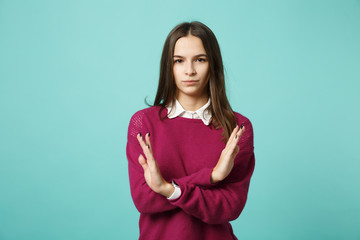 Obraz premium Young fun sad upset perplexed disturb woman girl showing stop gesture with crossed folded hands posing isolated on blue wall background studio portrait. People lifestyle concept. Mock up copy space.