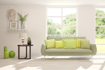 Stylish room in white color with sofa and summer landscape in window. Scandinavian interior design. 3D illustration