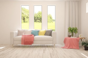 Stylish room in white color with sofa and summer landscape in window. Scandinavian interior design. 3D illustration