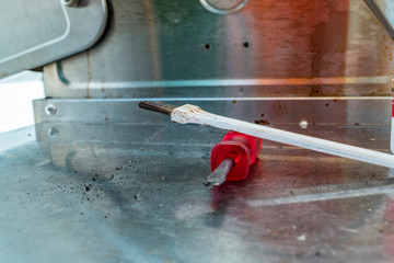 Grill cleaner with screwdriver on the grill