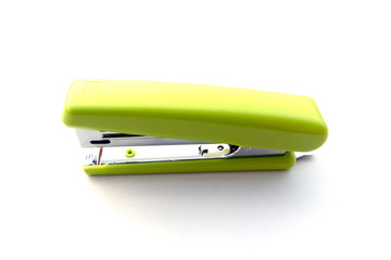 Green stapler isolated on white background.