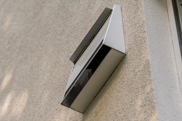 modern ventilation system on the outer wall of a new house photographed from below