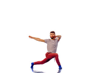 Fototapeta na wymiar Handsome breakdancer does a common dance pose isolated on white