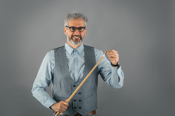 studio shot of billiard player holding stick