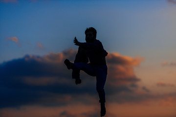 Athletic silhouette dancer in a super jumping pose