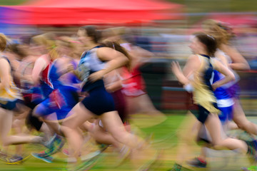Group of female athletes running.