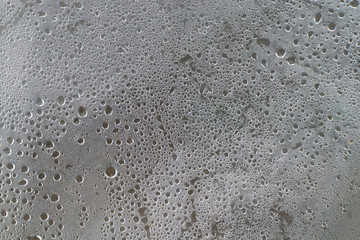 Translucent polyethylene with moisture drops from condensation on the inside as a background