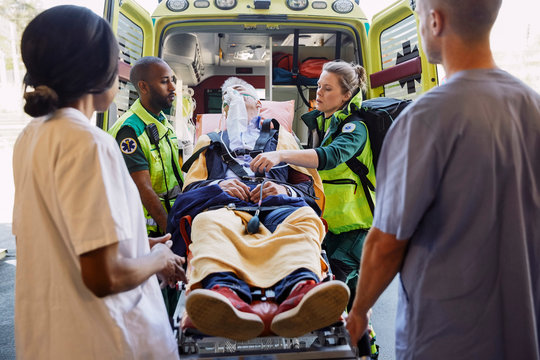 Paramedics taking out patient from ambulance