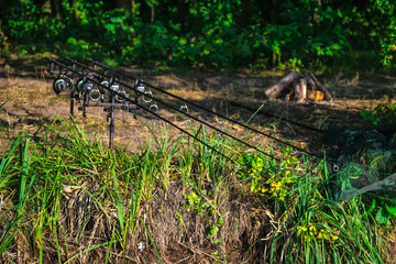 Carpfishing session at the Lake.Carp Angling scenic landscape overlooking lake at Dawn.Fishing adventures, carp fishing.Carp fishing rods, fishing line, freshwater water reflection