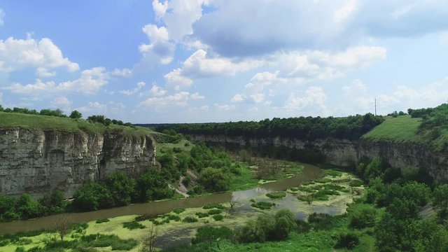 Aerial video of a beautiful snaky swamp in sunny day. 4K.
