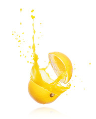 Juice splashes out of a cut orange, isolated on white background