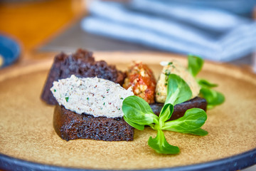 Rye bread with paste of nuts lying on the plate.