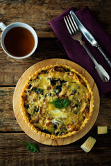 bacon spinach quiche with fresh spinach leaves